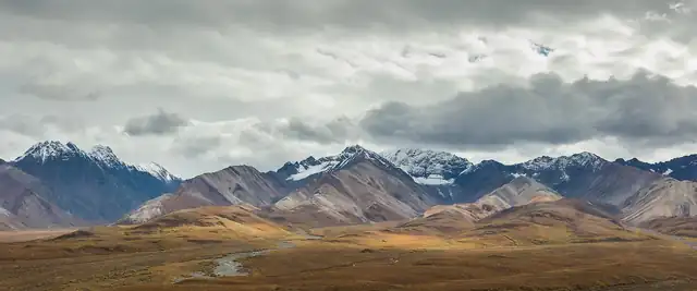 Snow-capped Alaska Range rising above tundra in Denali National Park, Alaska
